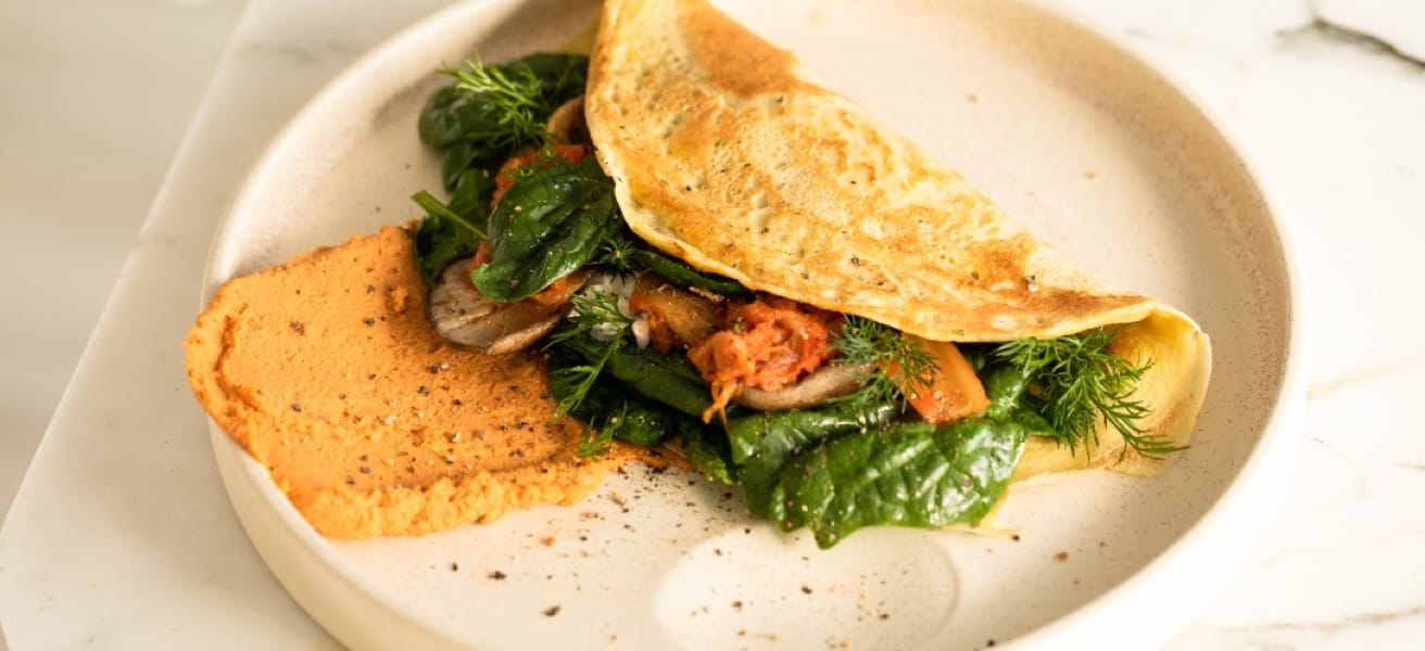 Omelette with vegetables in a white plate